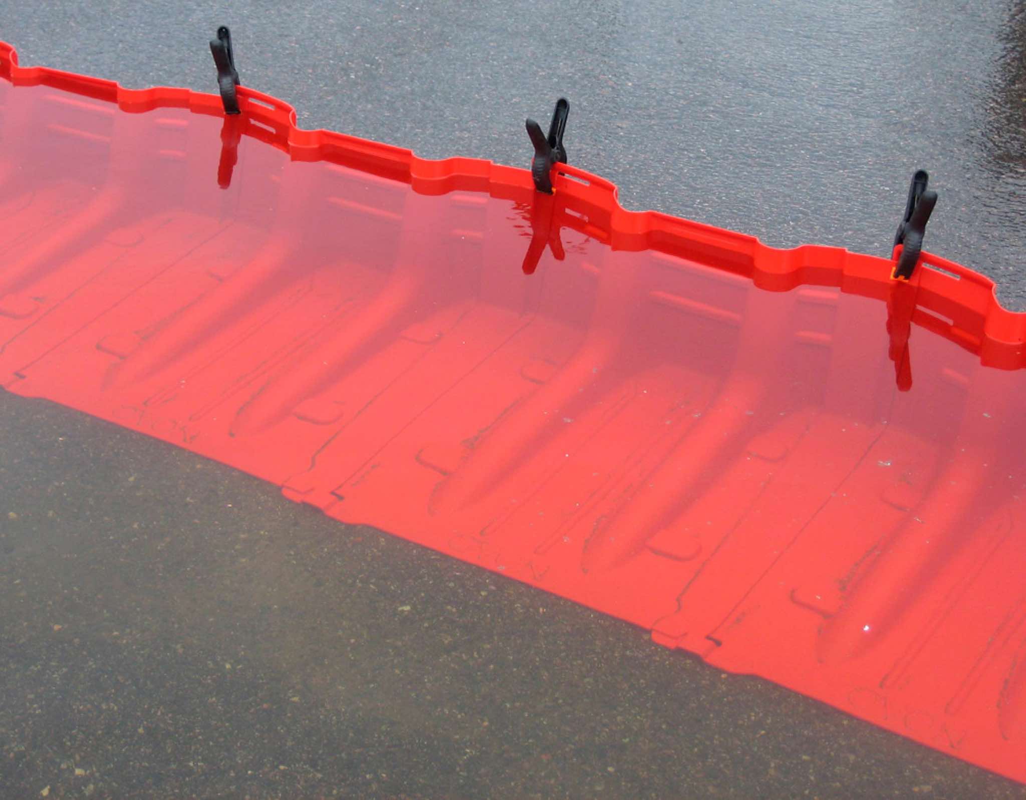 Freestanding temporary flood barrier designed for fast response to flood threats in an urban environment, on hard and even surfaces like tarmac, paving and concrete.