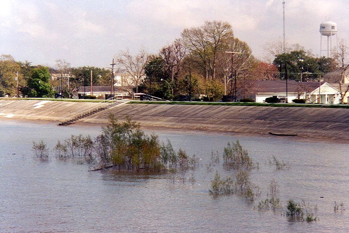 A levee keeps high water on the Mississippi River from flooding Gretna, Louisiana, in March 2005.
